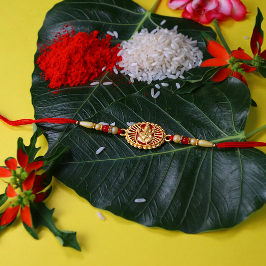 Traditional Ganesha Rakhi With Golden Finish And Sacred Red Thread